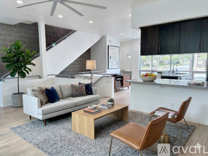 A living room with a couch, a coffee table, and a chair.
