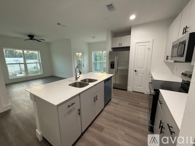 A kitchen with white cabinets and a sink.