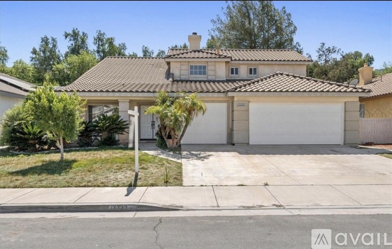 A house with a brown roof and a white garage door.