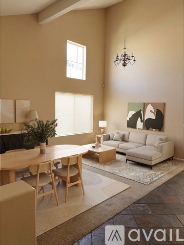 A living room with a couch, table, and chairs.