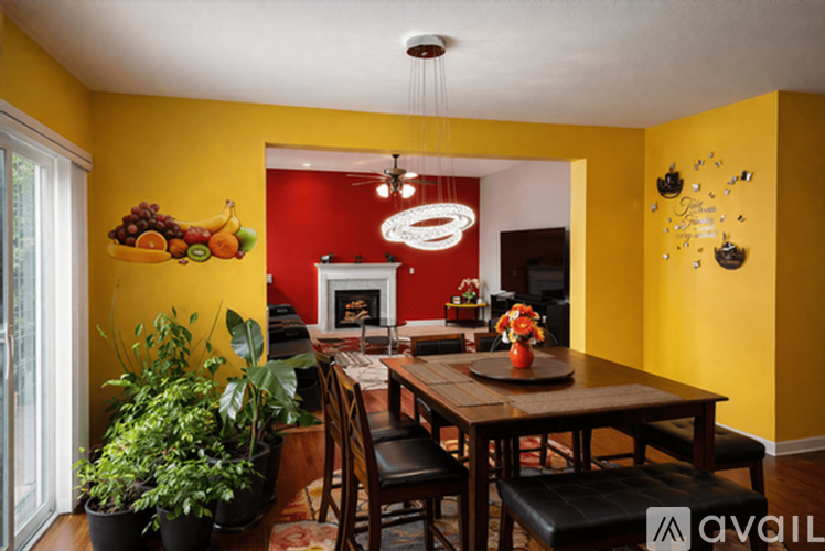 A dining room with a wooden table and chairs.