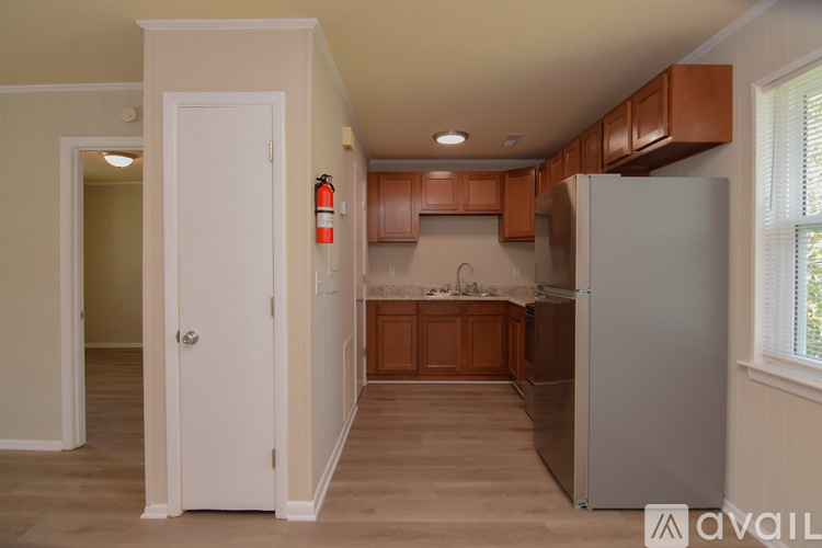 A kitchen with a white door and a white refrigerator.