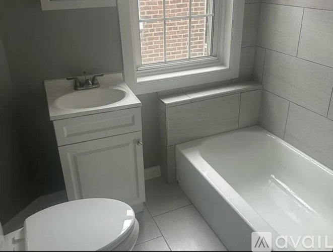 A white toilet sits next to a sink in a bathroom.