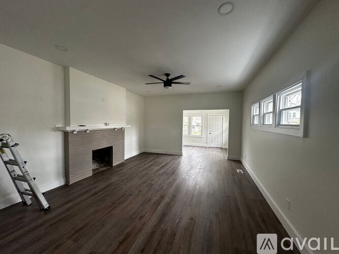 A room with a fireplace and a ladder.