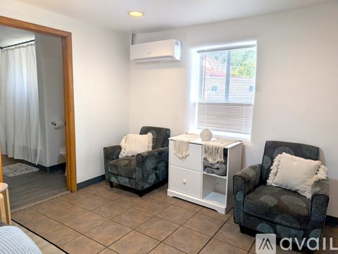 Two chairs and a table in a room.
