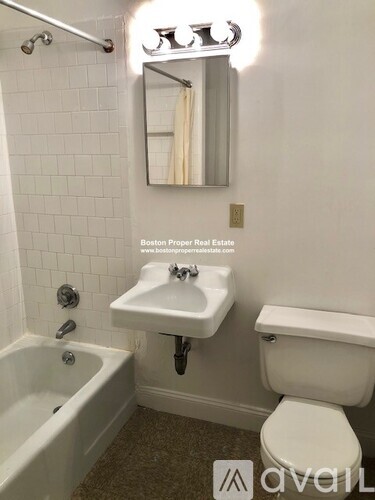 A white toilet sits next to a sink in a bathroom.