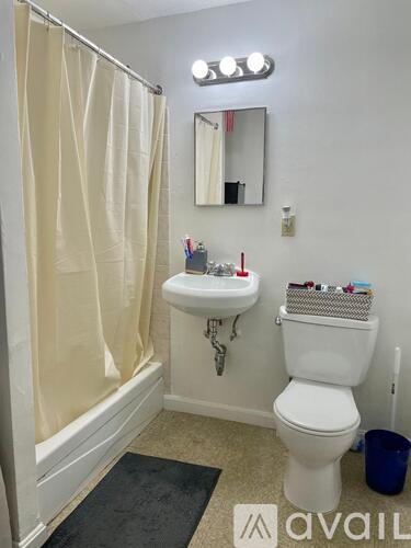 A white toilet sits next to a sink in a bathroom.