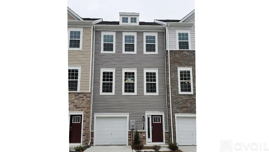 A grey house with a white garage door.