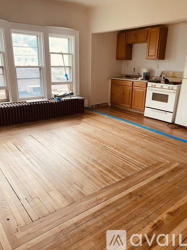 A kitchen with wooden floors and white appliances.
