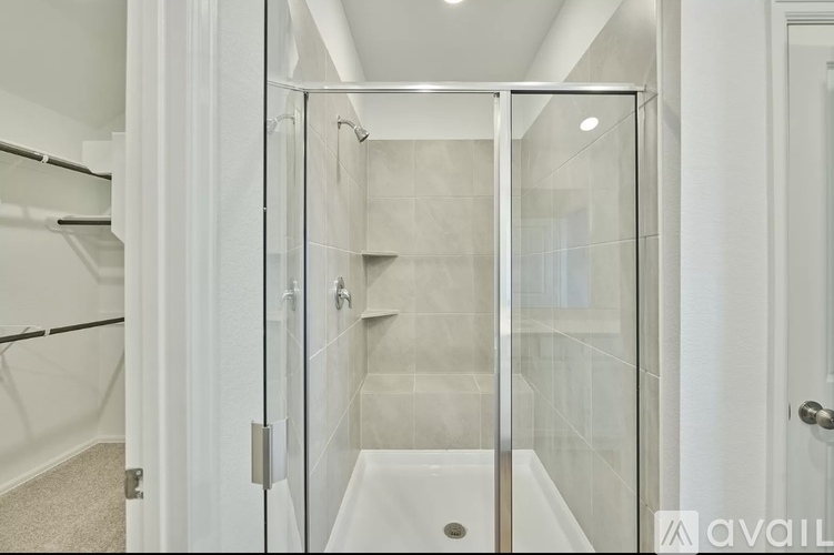 A white bathroom with a walk-in shower.