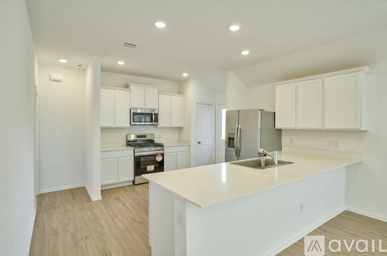 A kitchen with white cabinets and a large island.