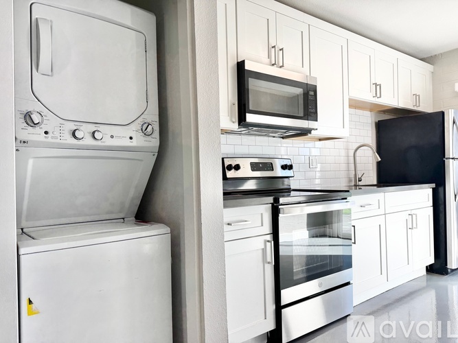 A white oven and microwave are on a kitchen counter.
