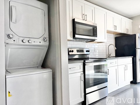 A white oven and microwave are on a kitchen counter.