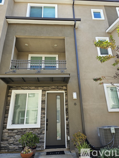 A two-story building with a balcony and a door.