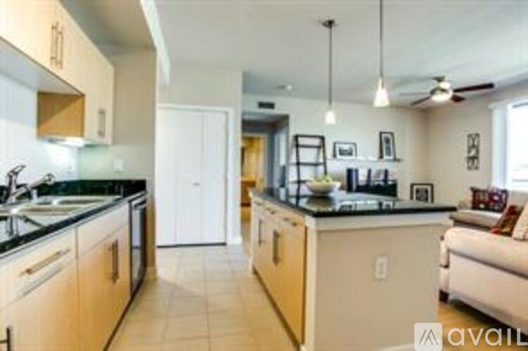 A kitchen with wooden cabinets and a black countertop.