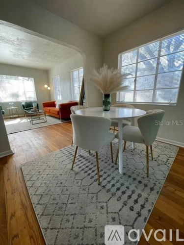 A living room with a white table and chairs.