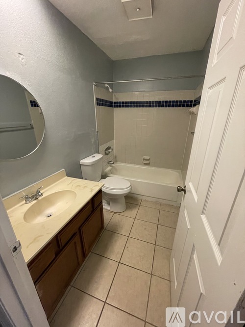A bathroom with a toilet, sink, and shower.