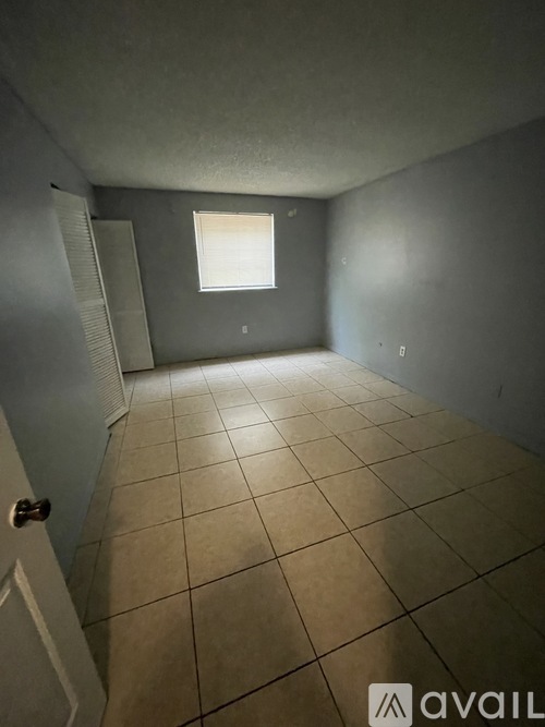 A room with tiled flooring and a window.