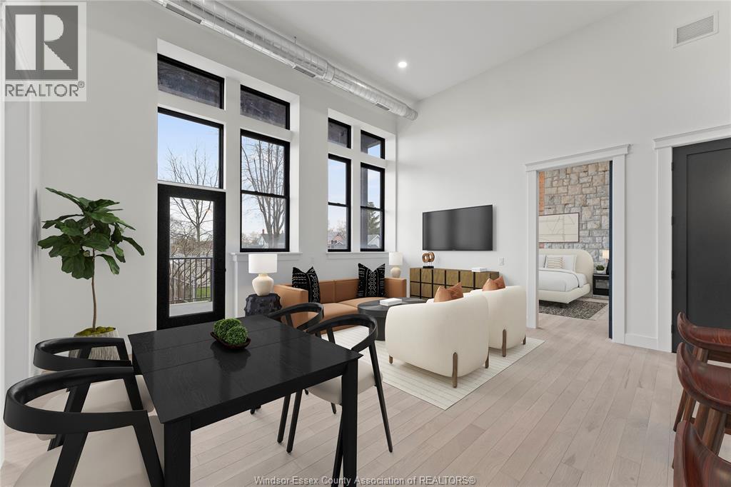 A modern living room with a black table and chairs.