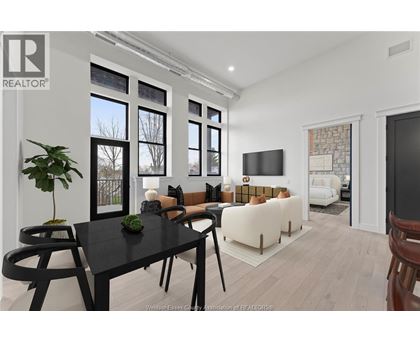 A modern living room with a black table and chairs.