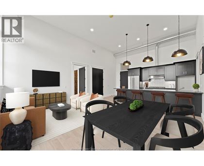A modern dining room with a black table and chairs.