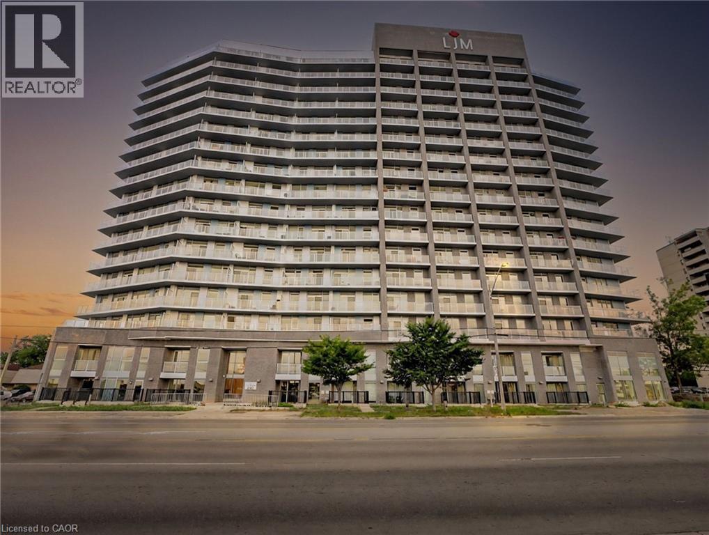 A tall building with the word "LIM" on the top is illuminated at dusk.