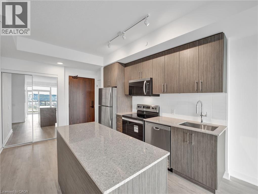 A modern kitchen with wooden cabinets and stainless steel appliances.