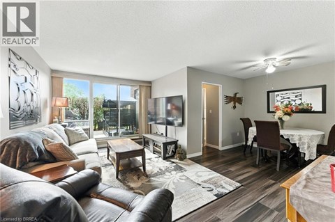 A living room with a brown leather couch and a grey sofa.