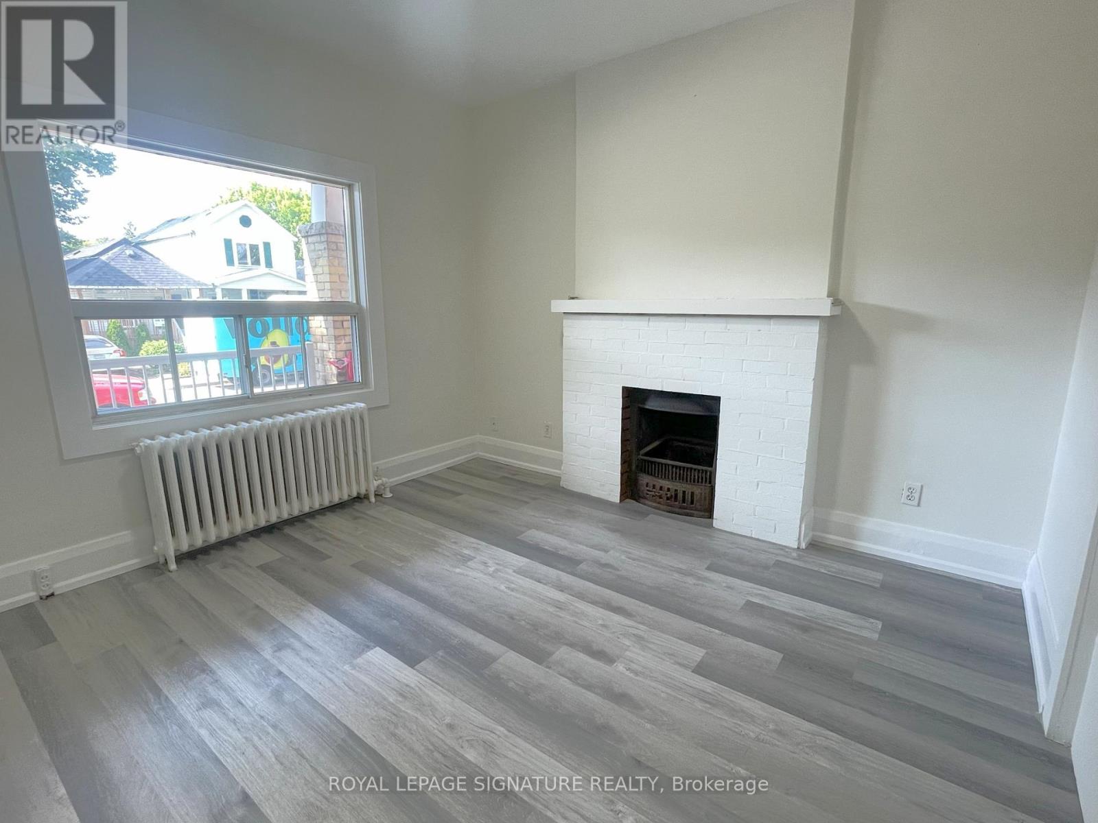 A room with a fireplace and a window.