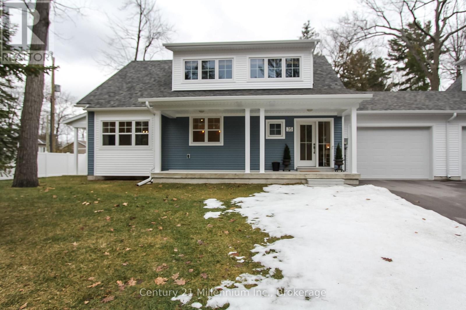A two story house with a garage on the right.