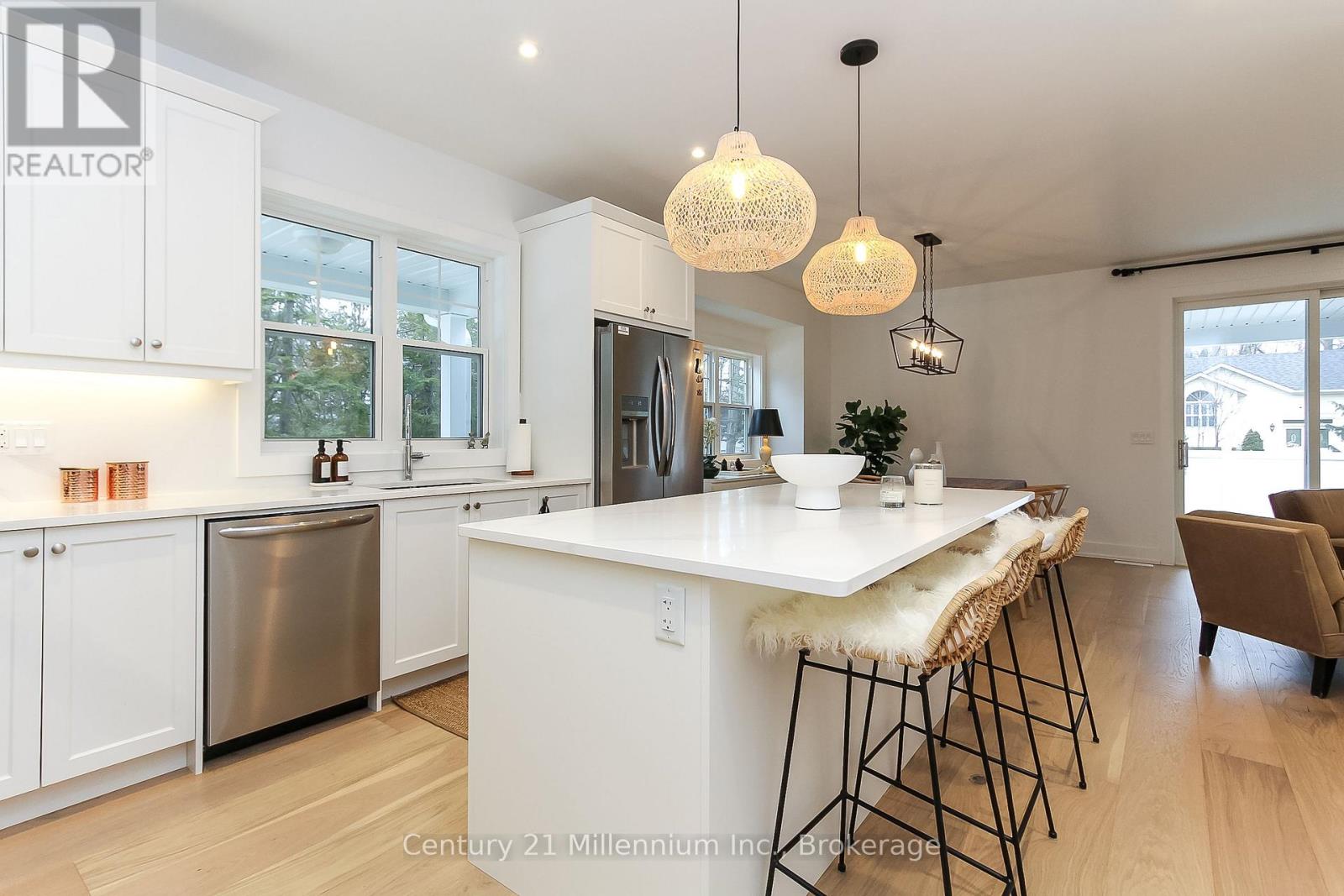A modern kitchen with white cabinets and a large island.