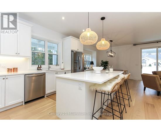 A modern kitchen with white cabinets and a large island.