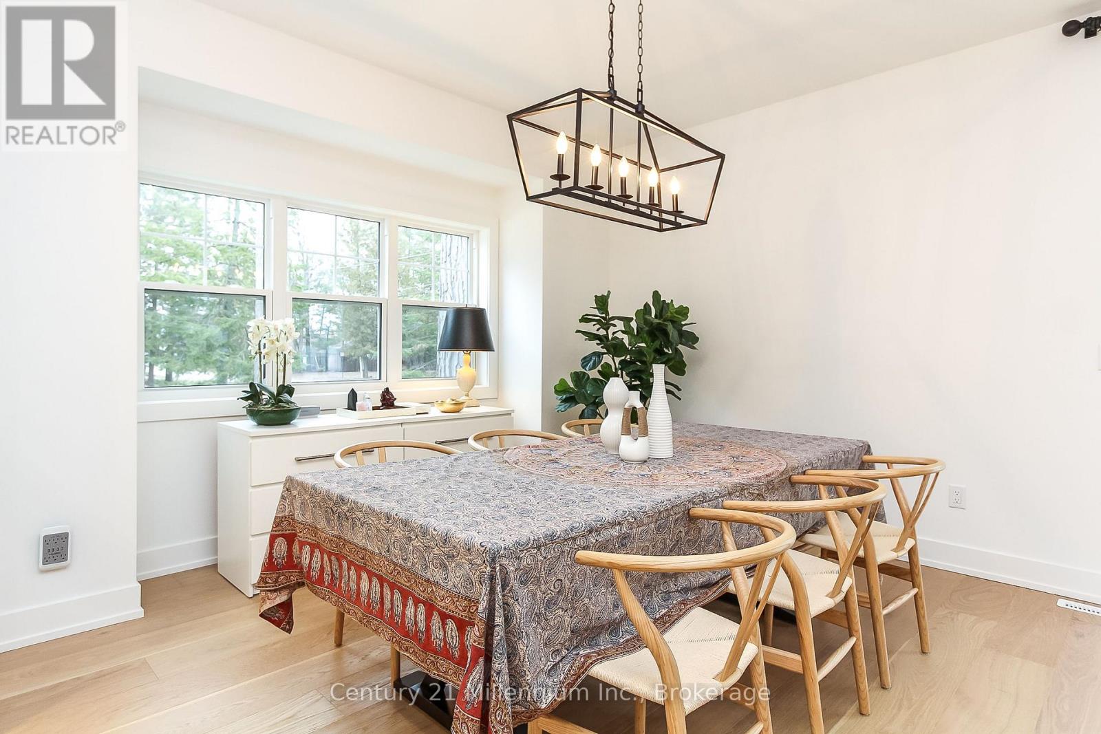A dining room with a table set for four.