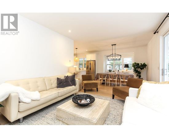 A living room with a beige couch and a coffee table.