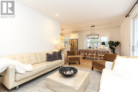 A living room with a beige couch and a coffee table.