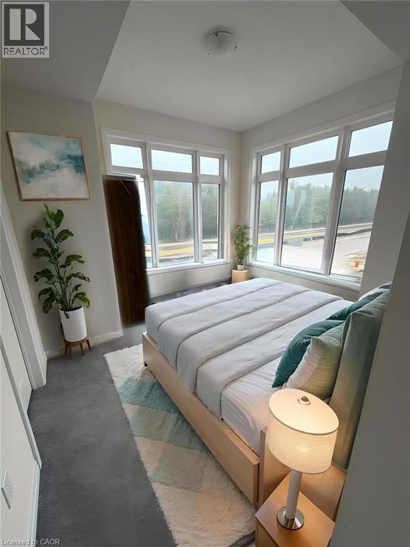 A bedroom with a large bed and a painting on the wall.