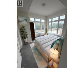 A bedroom with a large bed and a painting on the wall.