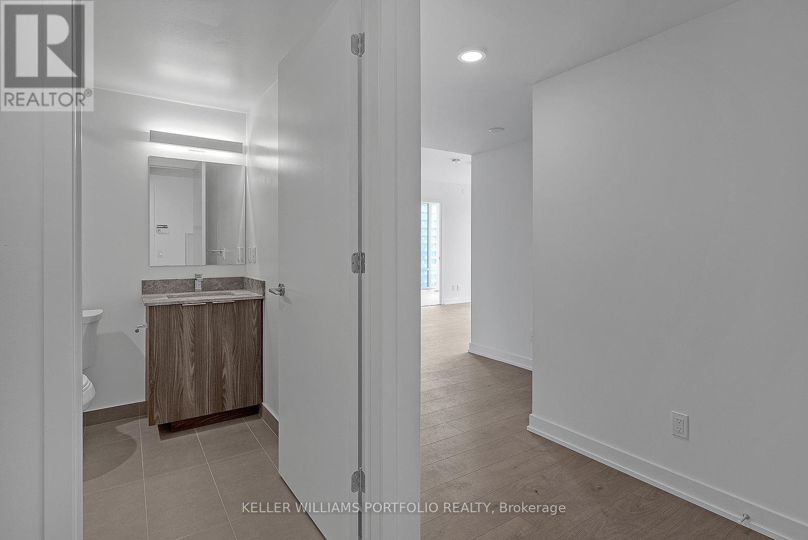 A bathroom with a sink and mirror is shown in a real estate listing.