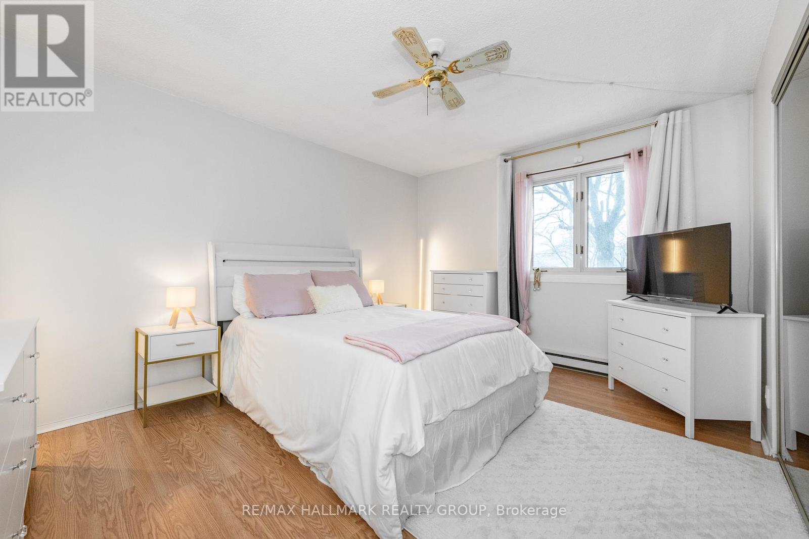 A bedroom with a bed, nightstand, and dresser.
