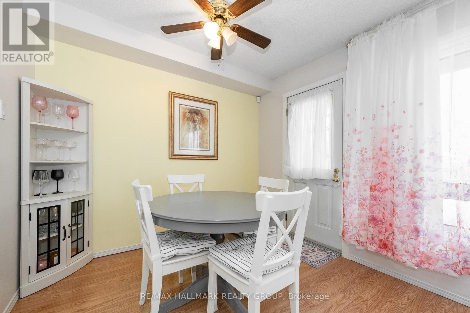 A dining room with a table and chairs.