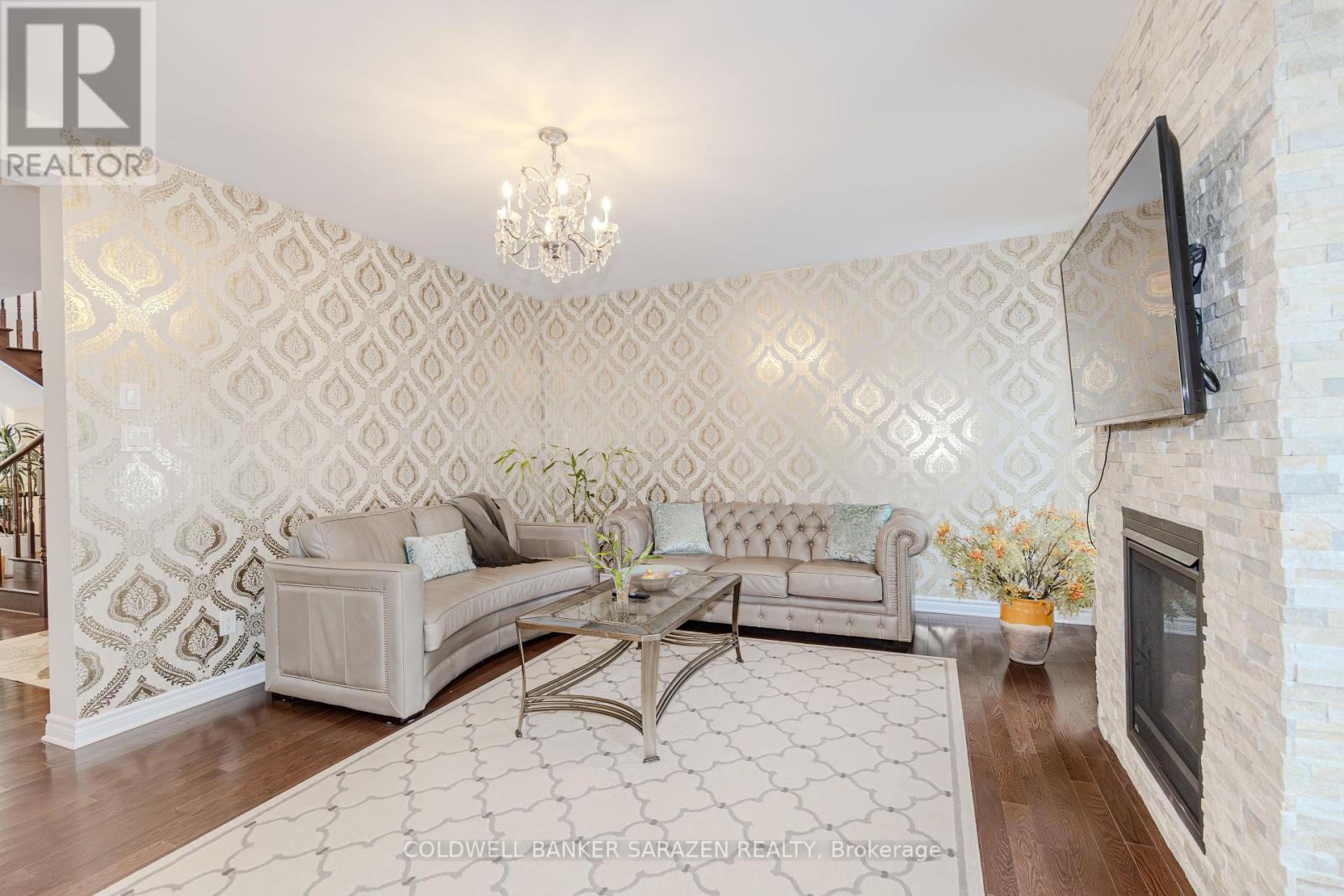 A living room with a grey sofa and a glass coffee table.