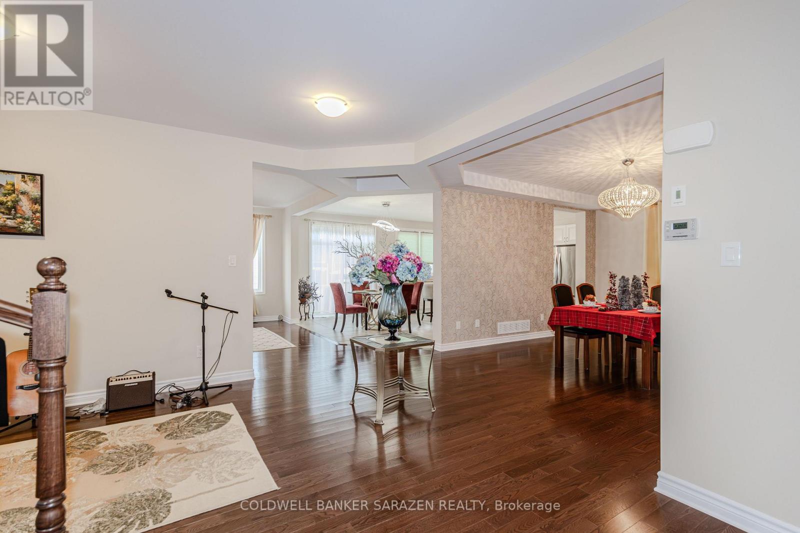 A dining room with a table set for a meal.