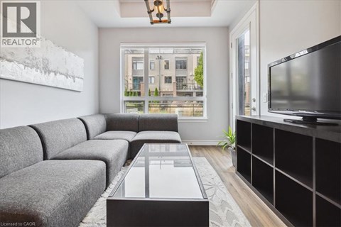 A living room with a grey couch and a coffee table in front of a large window.