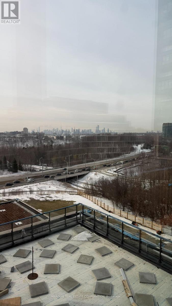A view from a high vantage point looking down at a snowy landscape with a cityscape in the distance.