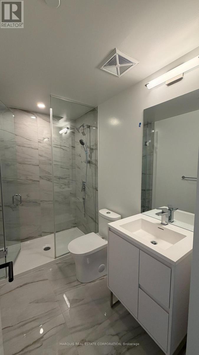 A bathroom with a white sink and a walk-in shower.