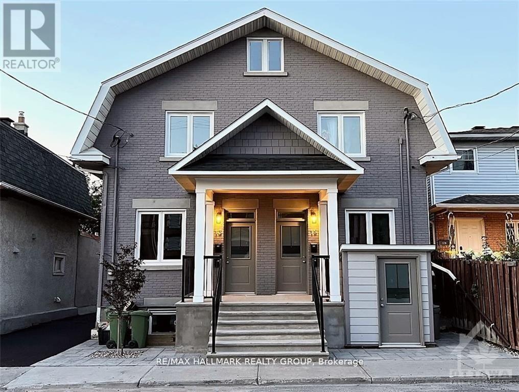 A house with a grey facade and a brown door is shown.