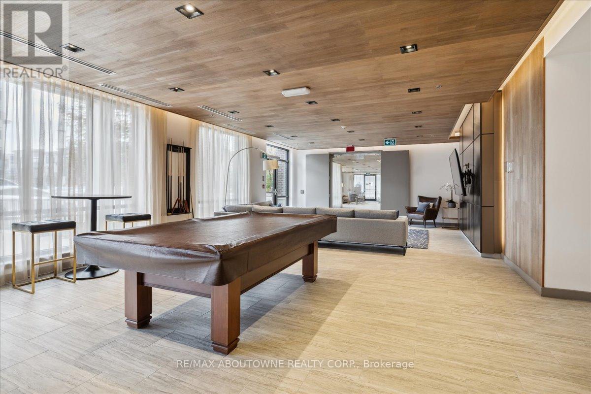 A spacious room with a pool table and a television.