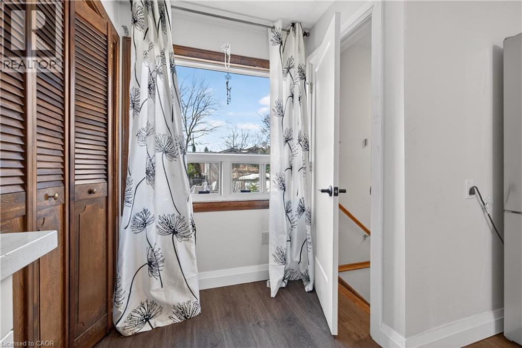 A room with a window and a view of trees outside.