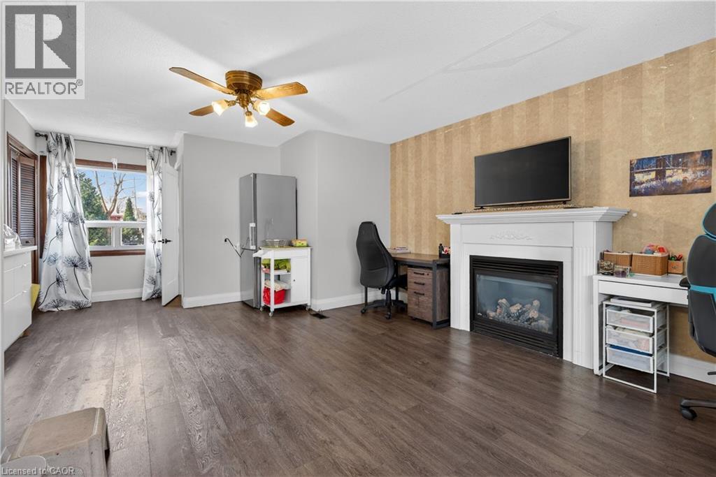A living room with a fireplace and a television.