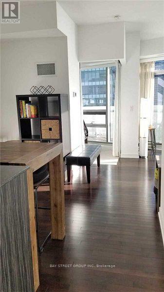 A dining room with a wooden table and chairs.